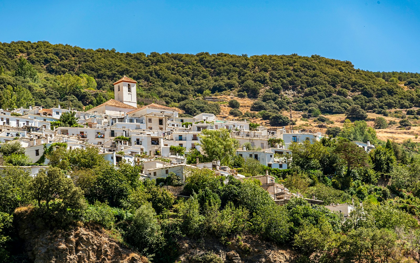 Village of Capileira across Poqueira valley, Las Alpujarras, Sierra Nevada, Andalusia, Spain.