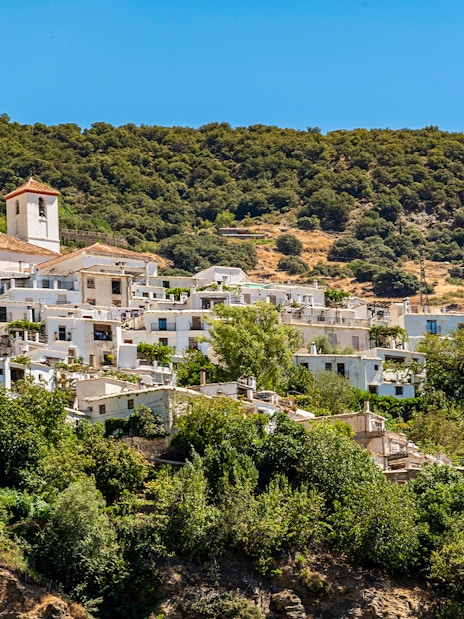 Village of Capileira across Poqueira valley, Las Alpujarras, Sierra Nevada, Andalusia, Spain.