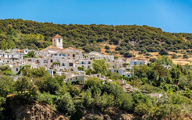 Village of Capileira across Poqueira valley, Las Alpujarras, Sierra Nevada, Andalusia, Spain.