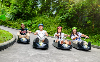 Friends enjoying a ride on the Skyline Luge track in Singapore.