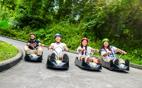 Friends enjoying a ride on the Skyline Luge track in Singapore.