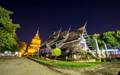 Chiang Mai temple illuminated at night during a bike tour.