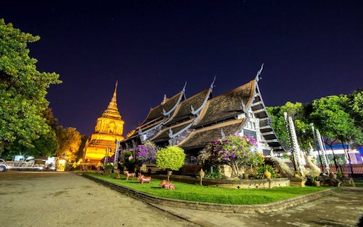 Chiang Mai temple illuminated at night during a bike tour.
