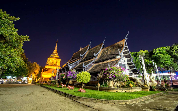 Chiang Mai temple illuminated at night during a bike tour.