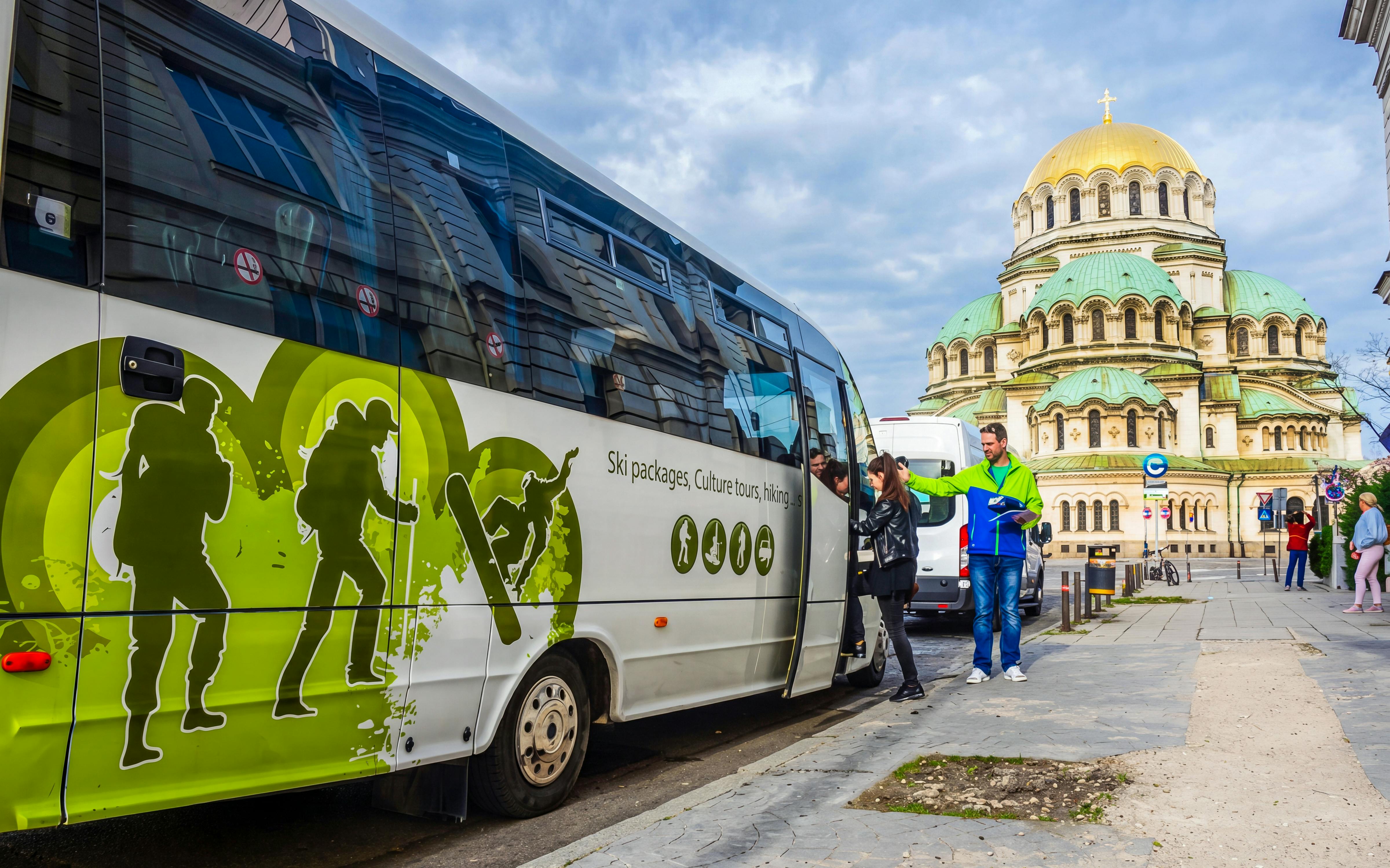 Tour bus near Alexander Nevsky Cathedral in Sofia, Bulgaria, for Rila Monastery and Boyana Church trip.