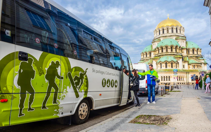 Tour bus near Alexander Nevsky Cathedral in Sofia, Bulgaria, for Rila Monastery and Boyana Church trip.
