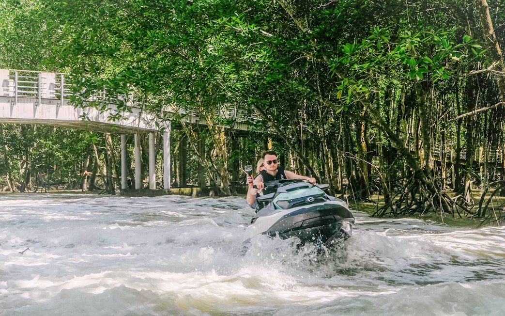 Jet ski navigating through mangroves in Langkawi's UNESCO Kilim Geopark.