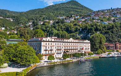 Villa d'Este luxury hotel on Lake Como, Cernobbio, with lush hillside backdrop.