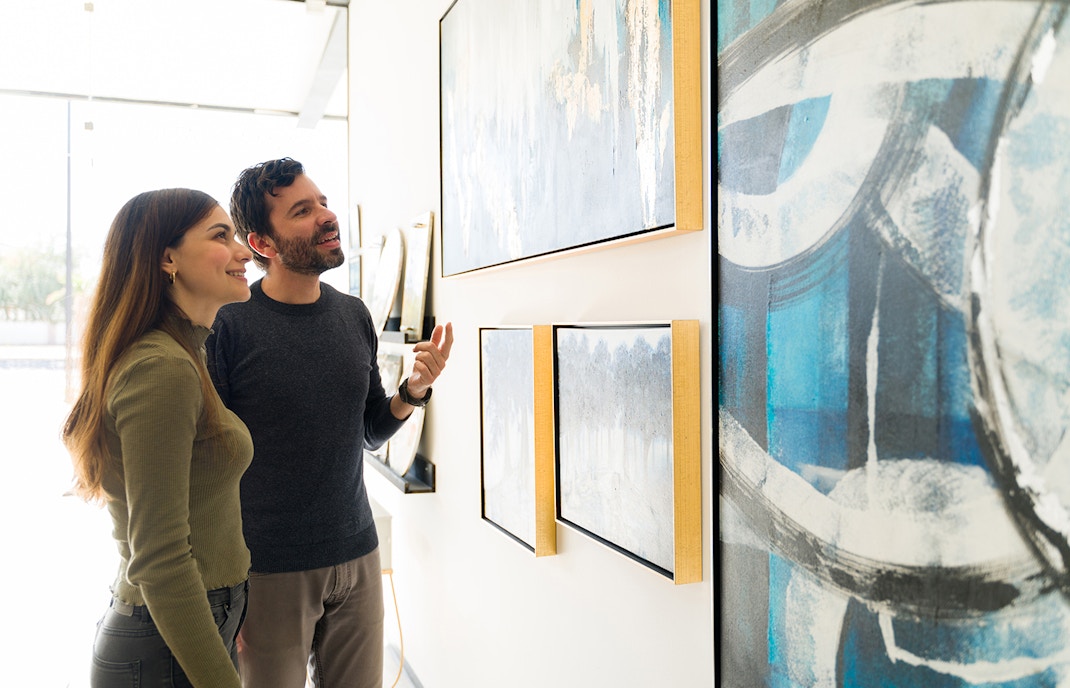 A couple in awe looking at the Henri Rousseau, The Dream Painting