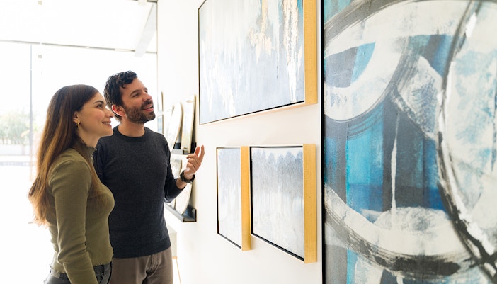 A couple in awe looking at the Henri Rousseau, The Dream Painting