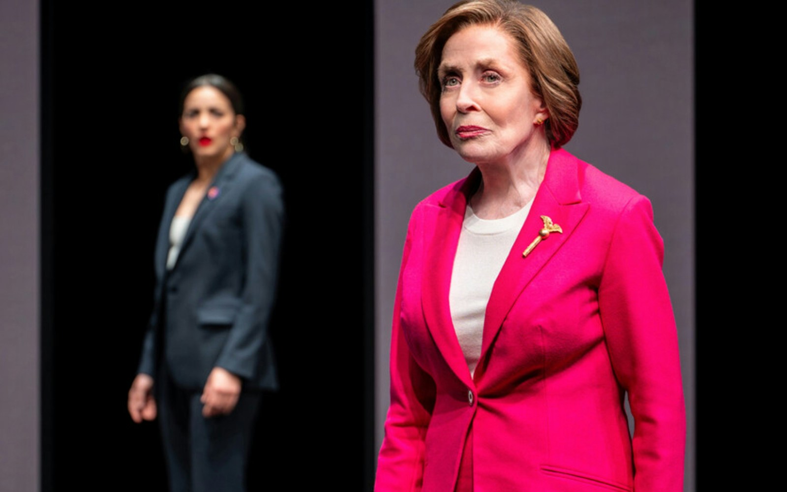 Two actors on stage during a dramatic scene in a play.