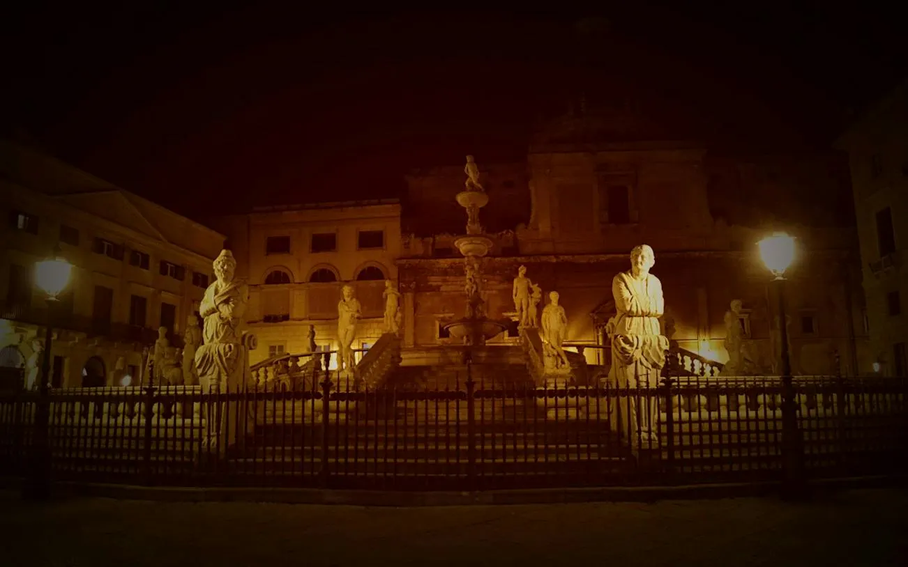 Piazza Pretoria statues illuminated at night, Palermo, part of Haunted Palermo Vengeful Ghosts tour.