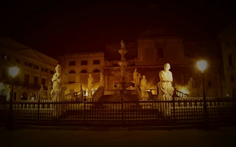 Piazza Pretoria statues illuminated at night, Palermo, part of Haunted Palermo Vengeful Ghosts tour.