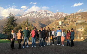 Group of people standing in front of the Andes Mountains in Chile.