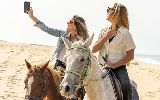 Horseback riding on a sandy beach in Comporta during Lisbon tour.