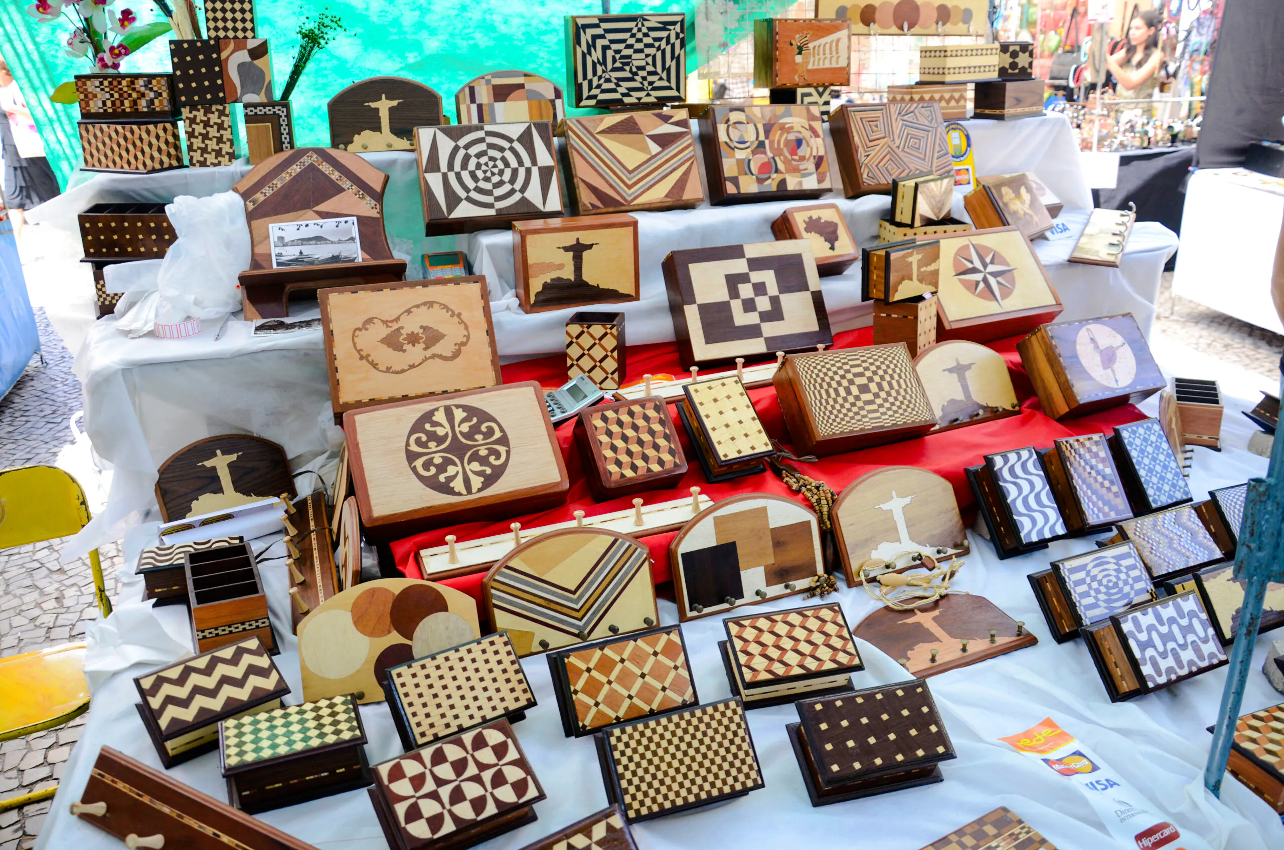 Wooden crafts display at Ipanema Hippie Fair, Rio de Janeiro, featuring intricate patterns and local designs.