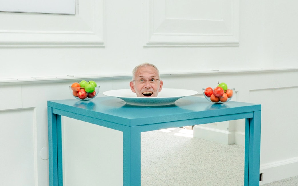 Head illusion on a table at Museum of Illusions Amsterdam.