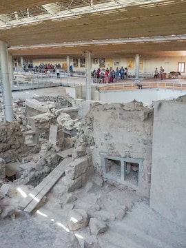 Visitors exploring ruins at Akrotiri Archaeological Site, Santorini.