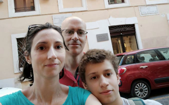Family exploring Rome street during Ghosts of Rome self-guided city game.