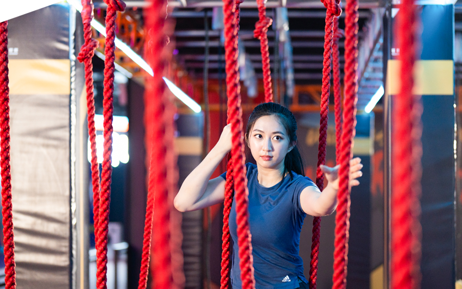Participant navigating rope course at Conquer Indoor Extreme Park, Monkey Canopy Resort.