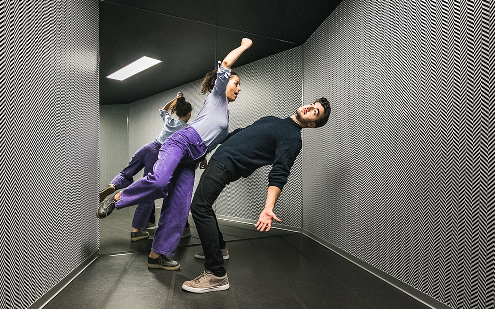 Visitors experiencing the anti-gravity room at Illuseum Berlin.