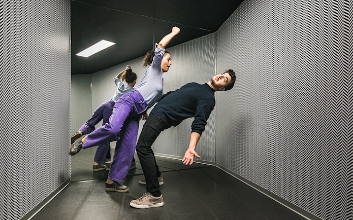 Visitors experiencing the anti-gravity room at Illuseum Berlin.
