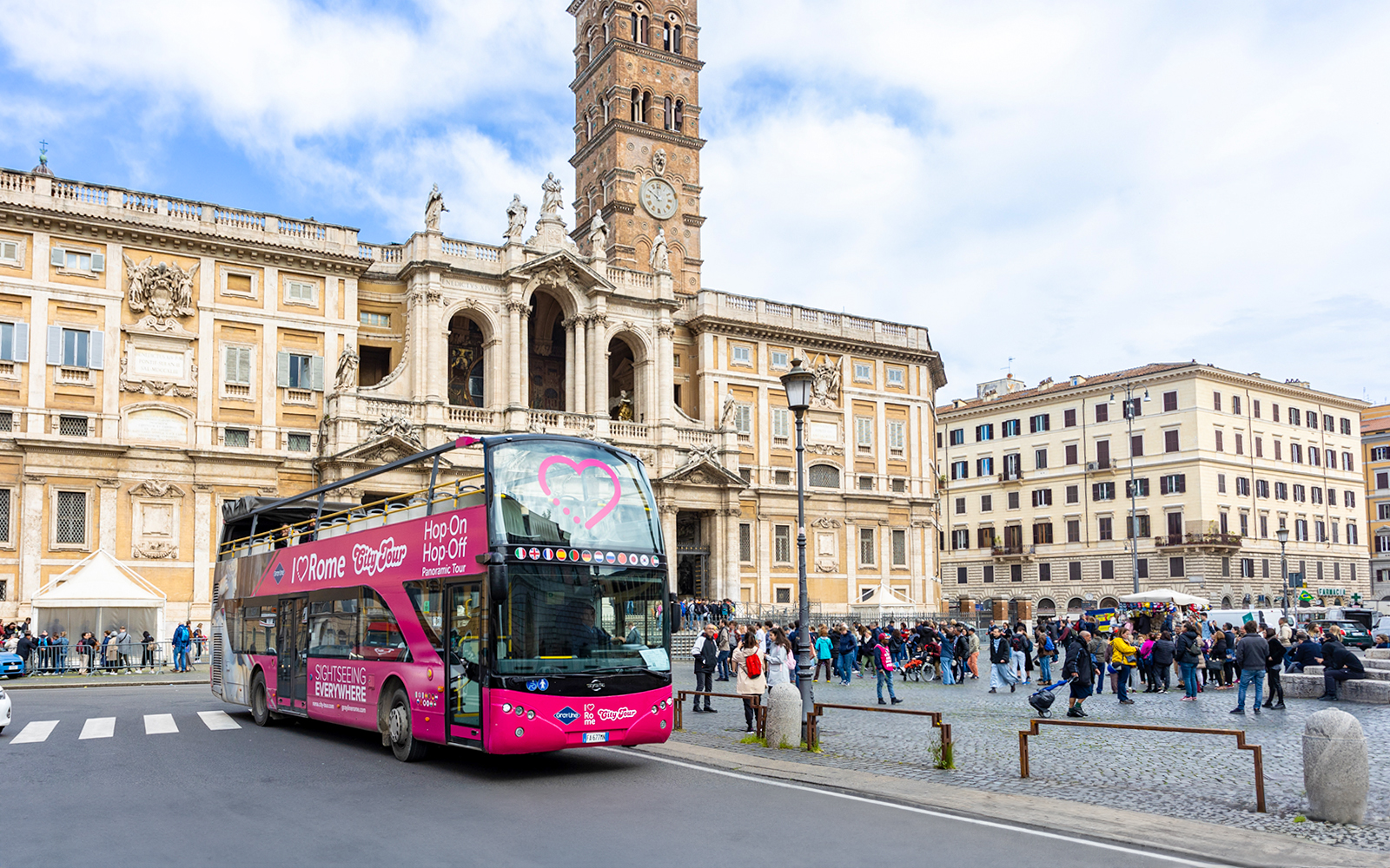Hop-on hop-off bus in front of Basilica Papale di Santa Maria Maggiore, Rome.
