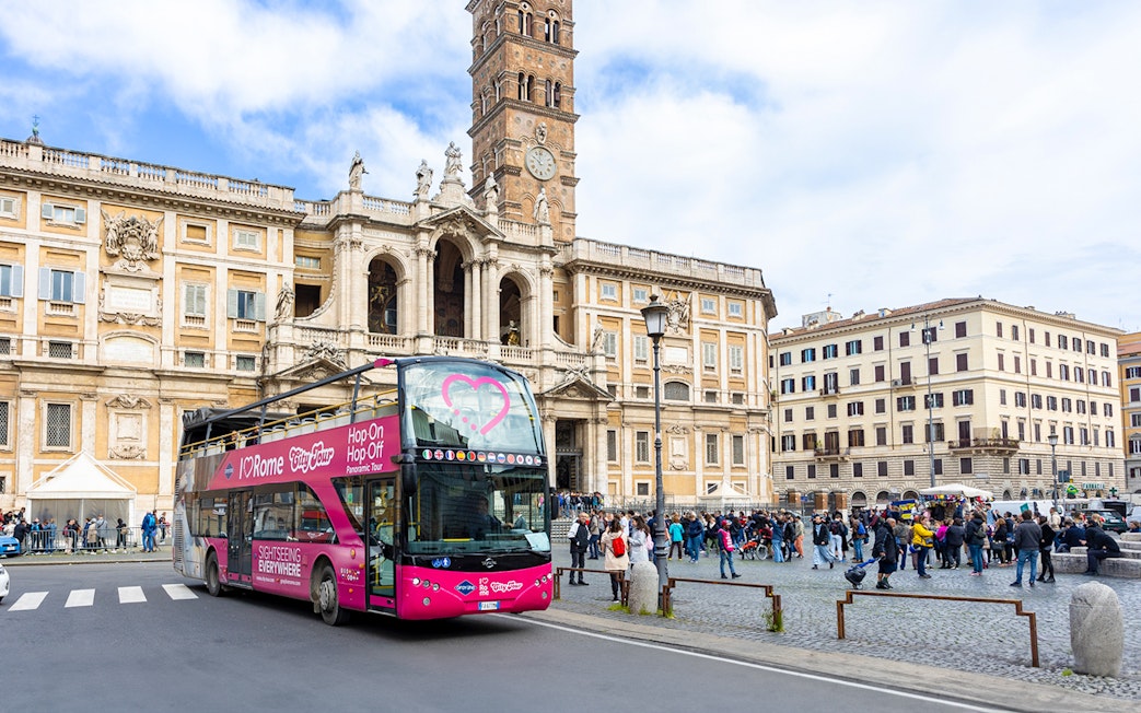Hop-on hop-off bus in front of Basilica Papale di Santa Maria Maggiore, Rome.