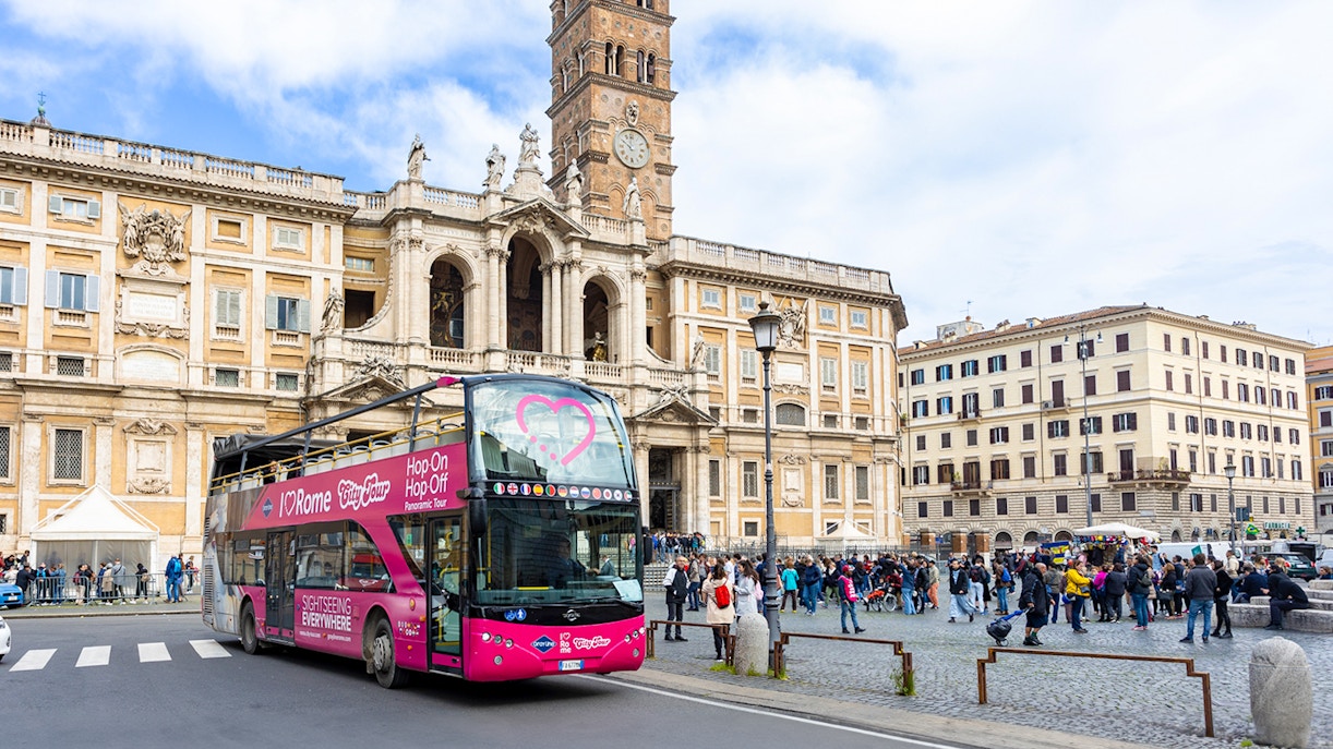 Hop-on hop-off bus in front of Basilica Papale di Santa Maria Maggiore, Rome.