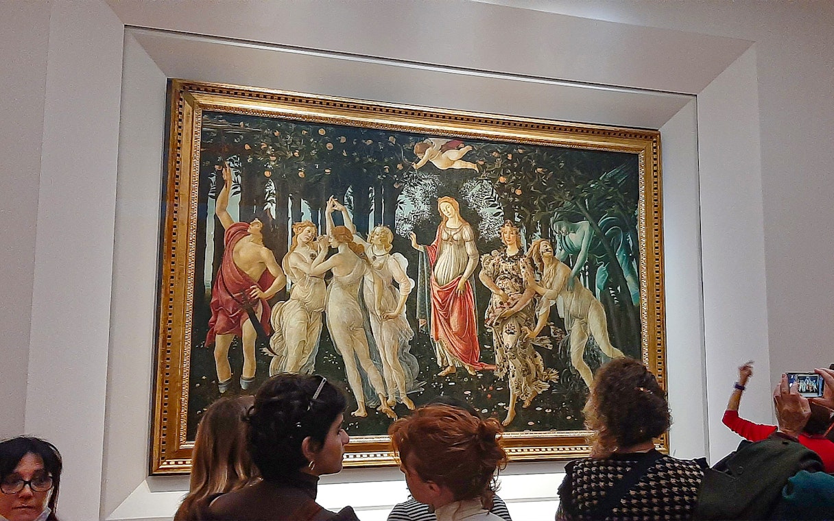 Visitors viewing Botticelli's "Primavera" at Uffizi Gallery, Florence.