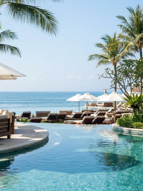 Finn's Beach Club poolside with ocean view and palm trees in Bali.