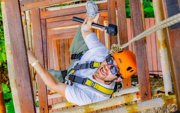 Adventurer climbing zipline tower at Sky Rock Zipline Adventure, Khao Lak.