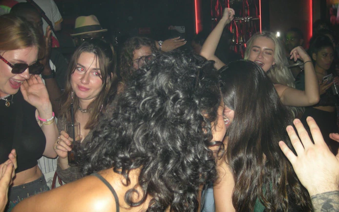 Group enjoying a lively night out during a Barcelona pub crawl.