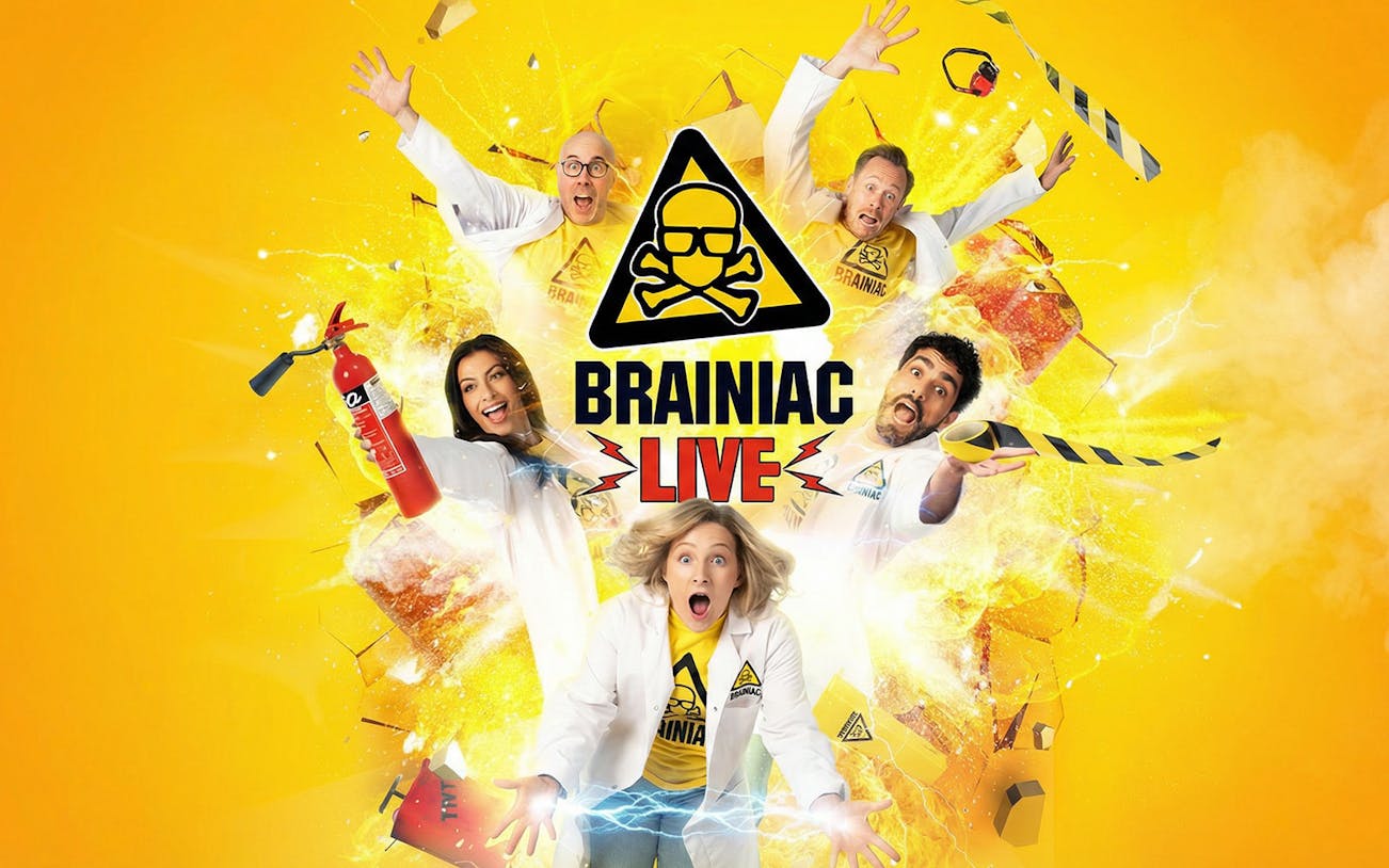 Performers in lab coats with explosive effects for Brainiac Live show.