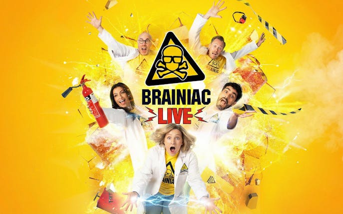 Performers in lab coats with explosive effects for Brainiac Live show.