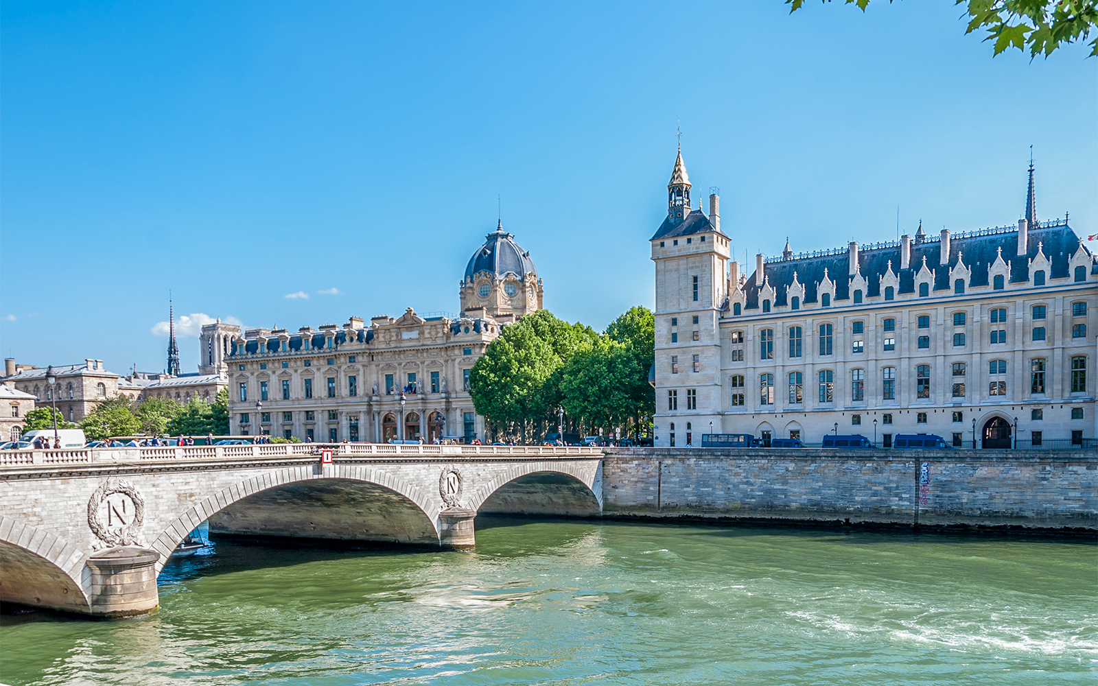 Pont Saint-Michel over the Seine River with historic buildings on Île de la Cité, Paris.