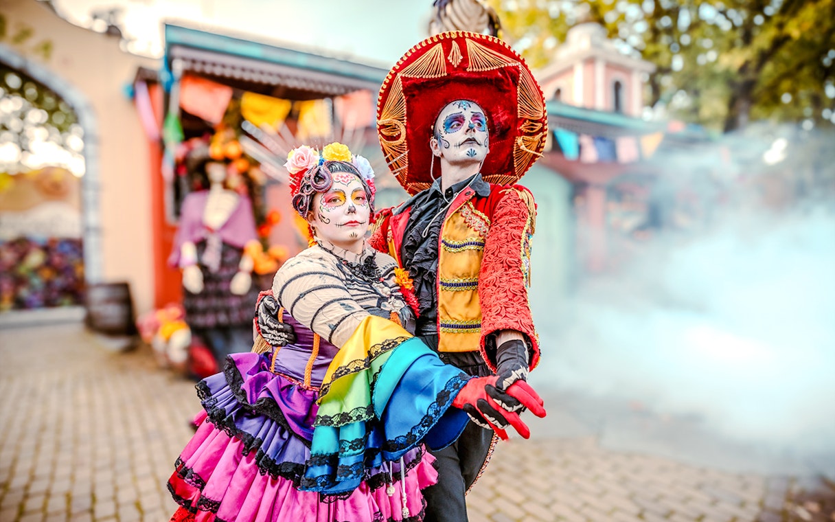 Performers in colorful costumes at Halloween event in Bobbejaanland, Belgium.