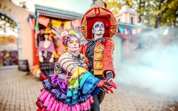 Performers in colorful costumes at Halloween event in Bobbejaanland, Belgium.