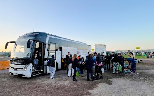 Passengers boarding a bus for transfers to London Victoria Station.