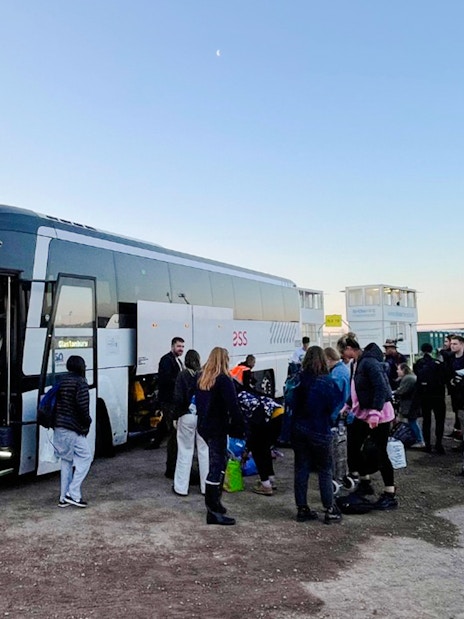 Passengers boarding a bus for transfers to London Victoria Station.
