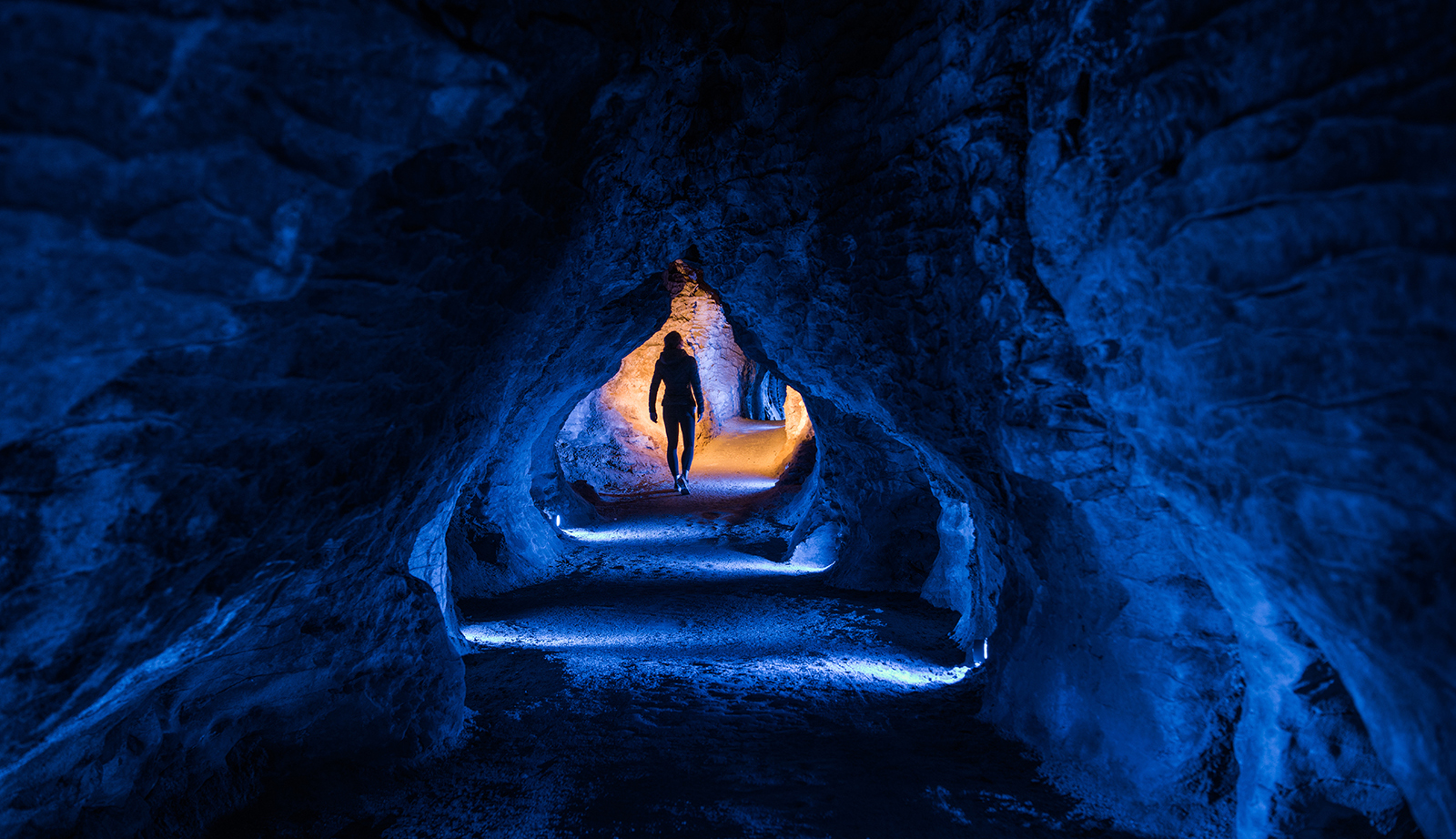 Ruakuri Cave guided tour showcasing illuminated limestone formations, Waitomo, New Zealand.