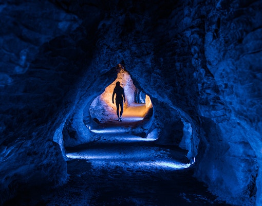 Ruakuri Cave guided tour showcasing illuminated limestone formations, Waitomo, New Zealand.