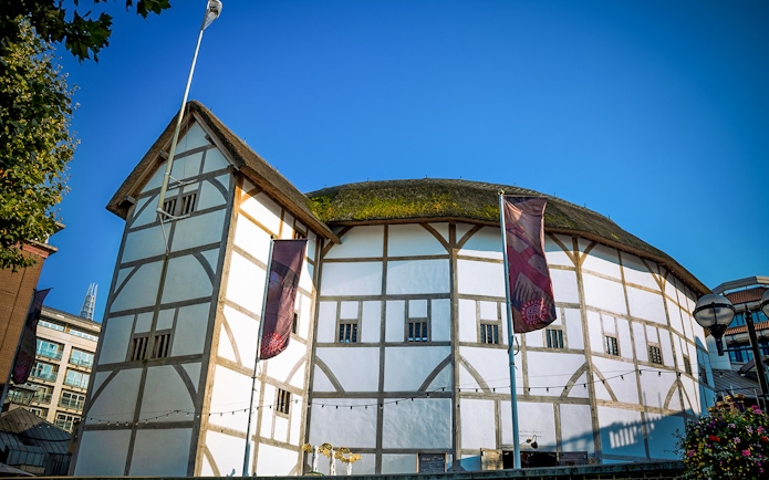 Shakespeare's Globe Theatre in London with its iconic thatched roof and timber frame.
