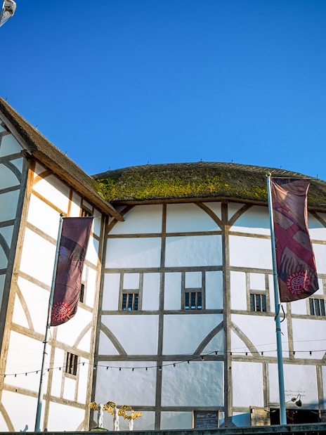 Shakespeare's Globe Theatre in London with its iconic thatched roof and timber frame.