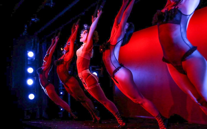 Performers on stage during Crazy Horse Show at Moulin Rouge, Paris.