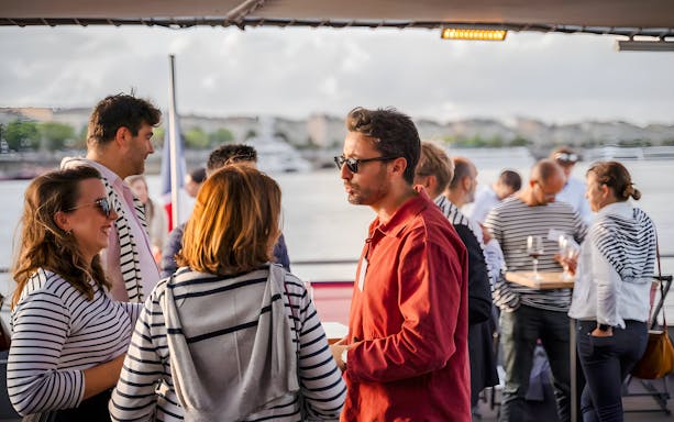 Guests socializing on the Bateaux Bordelais lunch cruise in Bordeaux, France.