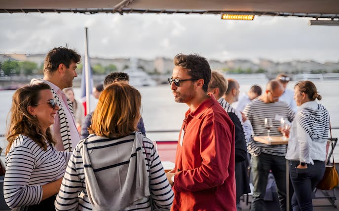 Guests socializing on the Bateaux Bordelais lunch cruise in Bordeaux, France.
