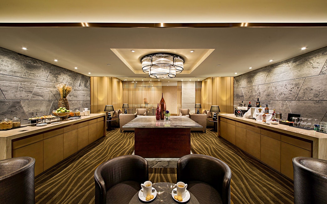 Plaza Premium Lounge interior with seating, refreshments, and modern decor.