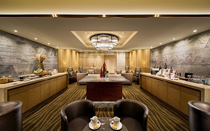 Plaza Premium Lounge interior with seating, refreshments, and modern decor.