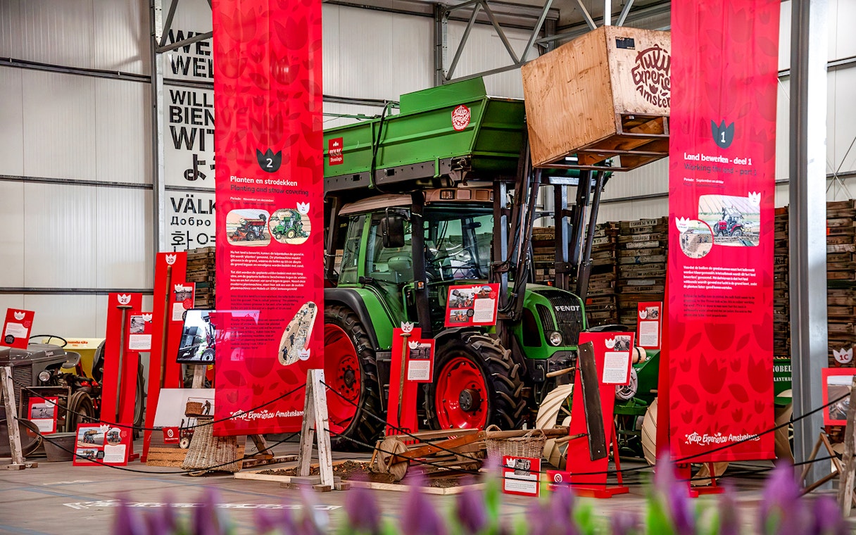 Exhibition display with tractor and informational panels at Keukenhof.